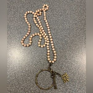 Elegant Beaded Necklace with Sun and Key Charms